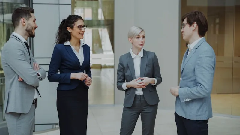 Business professionals conversing in modern office lobby